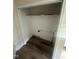 Spacious walk-in closet featuring vinyl floors, a shelf and hardware for washer/dryer hookups at 2503 Chapel Hill Rd, Durham, NC 27707