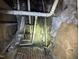 Exposed pipes and brick foundation within the crawlspace at 2503 Chapel Hill Rd, Durham, NC 27707