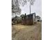 Another angle of the side exterior, showing the house, adjacent yard, and surrounding landscape at 2503 Chapel Hill Rd, Durham, NC 27707
