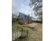 Rear view of the single-Gathering house, featuring a brick foundation and backyard space at 2503 Chapel Hill Rd, Durham, NC 27707