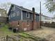 Back exterior view of the home, featuring brick accents, windows, and yard at 2503 Chapel Hill Rd, Durham, NC 27707