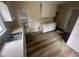 Kitchen featuring new laminate floors, white cabinets and views to another room at 2503 Chapel Hill Rd, Durham, NC 27707