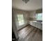 Functional kitchen with white cabinets, laminate floors and ample counter space at 2503 Chapel Hill Rd, Durham, NC 27707