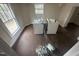 Bright laundry room with washer and dryer hookups and dark wood floor at 2503 Chapel Hill Rd, Durham, NC 27707