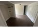 Bright room with wood-look floors and white walls; adjacent area has laundry hookups at 2503 Chapel Hill Rd, Durham, NC 27707