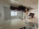 Bathroom with white tile, tub and shower combo, toilet and vanity with a window at 2505 Chapel Hill Rd, Durham, NC 27707