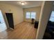 A bright bedroom with hardwood floors and a large window at 2505 Chapel Hill Rd, Durham, NC 27707