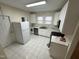 Bright kitchen features white cabinets, stainless steel appliances, and tile flooring at 2505 Chapel Hill Rd, Durham, NC 27707