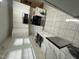 Bright kitchen featuring white cabinets, stainless steel appliances and marble countertops at 2505 Chapel Hill Rd, Durham, NC 27707
