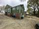 The back of the home features a brick foundation and many windows at 2505 Chapel Hill Rd, Durham, NC 27707