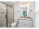 Bathroom featuring glass shower, granite countertop on vanity, white cabinets and neutral paint at 2801B Cannada Ave, Durham, NC 27704