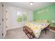 Bright bedroom featuring a colorful bedspread, natural light from the window, and neutral carpet at 2801B Cannada Ave, Durham, NC 27704