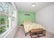 Bright bedroom featuring a colorful bedspread, natural light from the window, and neutral carpet at 2801B Cannada Ave, Durham, NC 27704