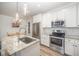 Gourmet kitchen featuring white cabinets, stainless steel appliances, and a large island at 2801B Cannada Ave, Durham, NC 27704