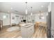 Modern open concept kitchen, features white cabinets, stainless appliances, and eat-in island at 2801B Cannada Ave, Durham, NC 27704