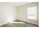 Cozy bedroom featuring wood-look flooring and natural light through a large window at 2819 Ricolden Trl, Elon, NC 27244