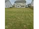 A spacious backyard with a lush green lawn and a view of the house's exterior at 30 Junius Birch Trl, Franklinton, NC 27525