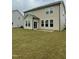 A large, grassy backyard with a view of the tan vinyl sided house at 30 Junius Birch Trl, Franklinton, NC 27525