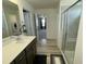 A bathroom featuring a single sink, a shower, and an open doorway at 30 Junius Birch Trl, Franklinton, NC 27525