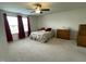 Bright bedroom featuring carpet floors, a ceiling fan and two large windows at 30 Junius Birch Trl, Franklinton, NC 27525