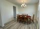 Bright dining area featuring a chandelier and a wooden table set for a cozy dinner at 30 Junius Birch Trl, Franklinton, NC 27525