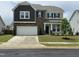 Beautiful two-story home with stone accents, a two-car garage, and manicured landscaping at 30 Junius Birch Trl, Franklinton, NC 27525
