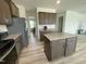 View of kitchen with granite countertops and stainless steel appliances leading to dining room at 30 Junius Birch Trl, Franklinton, NC 27525