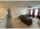 Spacious living room featuring neutral carpet, sofas, and window views at 30 Junius Birch Trl, Franklinton, NC 27525