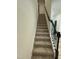 Carpeted staircase with decorative dark wood railing at 30 Junius Birch Trl, Franklinton, NC 27525