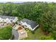 Aerial view of a beautiful townhome surrounded by mature trees, manicured landscaping, and designated parking spaces at 3021 White Cloud Cir, Apex, NC 27502
