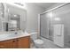 Bathroom featuring a vanity with sink, toilet, shower with glass doors and mirrored wall cabinet at 3021 White Cloud Cir, Apex, NC 27502