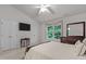 Spacious bedroom includes a mounted TV, closet and large, bright window at 3021 White Cloud Cir, Apex, NC 27502