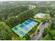 Aerial view of community amenities including tennis courts, basketball court, and a pool surrounded by trees at 3021 White Cloud Cir, Apex, NC 27502