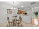 Cozy dining area features a glass table set and a view into the kitchen at 3021 White Cloud Cir, Apex, NC 27502