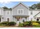 Charming two-story townhome with landscaped front yard, great daytime lighting, and an inviting entrance at 3021 White Cloud Cir, Apex, NC 27502