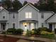Charming two-story townhome with landscaped front yard, beautiful day time lighting, and inviting entrance at 3021 White Cloud Cir, Apex, NC 27502