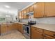 Functional kitchen with wooden cabinets, stainless steel appliances, and plenty of counter space at 3021 White Cloud Cir, Apex, NC 27502