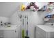 Functional laundry room equipped with a washer, a dryer, and shelving at 3021 White Cloud Cir, Apex, NC 27502
