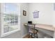 Dedicated office space with built-in desk, natural light, and vinyl floors at 3021 White Cloud Cir, Apex, NC 27502