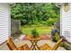 Private outdoor patio featuring brick flooring, wooden chairs, side yard, and wooded views at 3021 White Cloud Cir, Apex, NC 27502