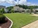 Beautiful backyard featuring lush green grass, a black fence, and a glimpse of the refreshing pool, perfect for outdoor enjoyment at 329 Broad Elm Ln, Apex, NC 27523
