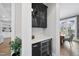 A modern bar area with black cabinets, wine cooler, and countertop space, perfect for entertaining at 329 Broad Elm Ln, Apex, NC 27523