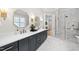 A well-lit bathroom with double sinks, granite counters, stylish fixtures, and a glass-enclosed shower at 329 Broad Elm Ln, Apex, NC 27523