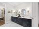 A spacious bathroom with double vanities, modern fixtures, and a view of a walk-in closet at 329 Broad Elm Ln, Apex, NC 27523