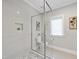Modern bathroom with a glass-enclosed shower, white tiles, and sleek fixtures at 329 Broad Elm Ln, Apex, NC 27523