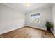 A bright bedroom with hardwood floors, a large window, and ample natural light at 329 Broad Elm Ln, Apex, NC 27523