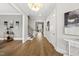 Open foyer featuring hardwood floors, neutral paint, stairs, and a view to the living room at 329 Broad Elm Ln, Apex, NC 27523