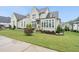 An eye-level exterior view with professionally maintained landscaping and vibrant green grass at 329 Broad Elm Ln, Apex, NC 27523