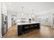 Open concept kitchen with a large island, stainless steel appliances, and access to the laundry room at 329 Broad Elm Ln, Apex, NC 27523