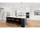 Modern kitchen features a large island with seating, stainless steel appliances, and custom cabinetry at 329 Broad Elm Ln, Apex, NC 27523